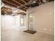 Unfinished basement with concrete floor and windows, with an exterior door at 6435 Ivey Creek Cir, Cumming, GA 30040
