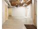 Unfinished basement area with exposed ductwork and concrete floors, and access to a storage area at 6435 Ivey Creek Cir, Cumming, GA 30040