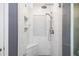 Modern walk-in shower with decorative tile and a built-in seat at 6435 Ivey Creek Cir, Cumming, GA 30040