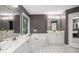 Large bathroom featuring dual sinks, a soaking tub, and white tile flooring at 6435 Ivey Creek Cir, Cumming, GA 30040