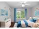 Decorated bedroom features a comfortable bed, white dresser, and natural light from the window at 6435 Ivey Creek Cir, Cumming, GA 30040