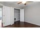 Bedroom features hardwood floors and closet with white bi-fold doors at 6435 Ivey Creek Cir, Cumming, GA 30040