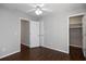 Bedroom features hardwood floors, ample closet space, and a ceiling fan at 6435 Ivey Creek Cir, Cumming, GA 30040