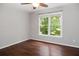 Empty bedroom features hardwood floors and a window letting in natural light at 6435 Ivey Creek Cir, Cumming, GA 30040