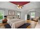 Staged bedroom with a king bed, tray ceiling, and natural light at 6435 Ivey Creek Cir, Cumming, GA 30040