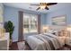 Cozy bedroom featuring light blue walls, hardwood floors, and neutral decor at 6435 Ivey Creek Cir, Cumming, GA 30040