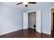 Light blue bedroom features hardwood floors and closet with white doors at 6435 Ivey Creek Cir, Cumming, GA 30040