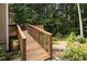 Inviting wooden deck and landscaping with a wooded backyard for outdoor enjoyment at 6435 Ivey Creek Cir, Cumming, GA 30040