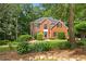 Charming two-story brick home with a well-manicured lawn and mature trees at 6435 Ivey Creek Cir, Cumming, GA 30040