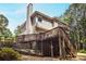 Exterior view of the house featuring a spacious deck and landscaped yard at 6435 Ivey Creek Cir, Cumming, GA 30040