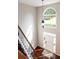 Open foyer view featuring a white door, a large window, and gleaming hardwood floors at 6435 Ivey Creek Cir, Cumming, GA 30040