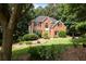 Beautiful brick home with well-manicured lawn and mature trees at 6435 Ivey Creek Cir, Cumming, GA 30040