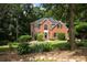 Charming two-story brick home with lush landscaping and mature trees at 6435 Ivey Creek Cir, Cumming, GA 30040