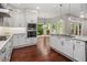 Updated kitchen with white cabinets, stainless steel appliances, granite countertops, and a view to the backyard at 6435 Ivey Creek Cir, Cumming, GA 30040
