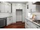 Updated kitchen with white cabinets, granite counters, stainless steel appliances, and hardwood floors at 6435 Ivey Creek Cir, Cumming, GA 30040