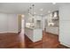 Well-lit kitchen featuring an island with a sink, stainless steel appliances and sleek, modern cabinetry at 6435 Ivey Creek Cir, Cumming, GA 30040