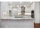 Gourmet kitchen island with granite countertop, stylish pendants, and ample cabinet space at 6435 Ivey Creek Cir, Cumming, GA 30040