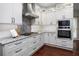 Modern kitchen with stainless steel appliances, gray cabinets, and hardwood floors at 6435 Ivey Creek Cir, Cumming, GA 30040