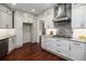 Updated kitchen featuring white cabinets, stainless steel appliances, and gray countertops at 6435 Ivey Creek Cir, Cumming, GA 30040