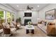 Bright living room with modern furnishings, a stone fireplace, and views to the outdoor greenery at 6435 Ivey Creek Cir, Cumming, GA 30040