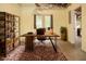 Basement office with built-in shelving, rug, and direct outdoor access at 6435 Ivey Creek Cir, Cumming, GA 30040