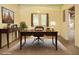 Bright home office featuring a large desk, console table, and French doors at 6435 Ivey Creek Cir, Cumming, GA 30040