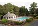 Community pool with lounge chairs, a gazebo, and mature trees create an inviting outdoor space at 6435 Ivey Creek Cir, Cumming, GA 30040
