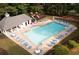 Aerial view of the community pool with lounge chairs, tables, and a playground nearby at 6435 Ivey Creek Cir, Cumming, GA 30040
