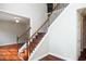 Elegant staircase with dark wood treads, iron spindles, and hardwood flooring at 6435 Ivey Creek Cir, Cumming, GA 30040