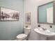 Powder room featuring beadboard accent wall and modern fixtures including a stylish pedestal sink at 947 Edwin Ln, Sugar Hill, GA 30518