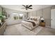 Serene bedroom with large windows, a ceiling fan, and neutral tones, creating a relaxing retreat at 947 Edwin Ln, Sugar Hill, GA 30518