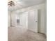 Spacious bedroom with neutral carpet, modern lighting, and an adjoining room with double doors at 947 Edwin Ln, Sugar Hill, GA 30518