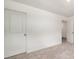 Carpeted bedroom featuring a large closet door and bright white walls at 947 Edwin Ln, Sugar Hill, GA 30518