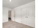 Bedroom with double doors to a closet, neutral carpet, and bright white walls at 947 Edwin Ln, Sugar Hill, GA 30518