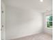 Bright, carpeted bedroom with a window offering natural light at 947 Edwin Ln, Sugar Hill, GA 30518