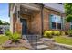 A welcoming front entrance with neatly landscaped flower beds and stone steps that create curb appeal at 947 Edwin Ln, Sugar Hill, GA 30518