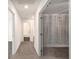 Bright hallway featuring carpet, white walls, and doors leading to various rooms at 947 Edwin Ln, Sugar Hill, GA 30518