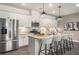 Bright kitchen boasts white cabinets, granite countertops, stainless steel appliances, and a spacious island at 947 Edwin Ln, Sugar Hill, GA 30518