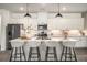 Bright kitchen featuring a large center island with seating, stainless steel appliances, and modern pendant lighting at 947 Edwin Ln, Sugar Hill, GA 30518
