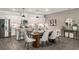 Bright kitchen featuring white cabinets, stainless steel appliances, a center island, and dining area at 947 Edwin Ln, Sugar Hill, GA 30518