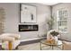 Stylish living room featuring an electric fireplace, plush seating, and a large picture window at 947 Edwin Ln, Sugar Hill, GA 30518