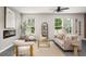 Bright living room with a modern fireplace, large windows, and stylish decor for a comfortable living space at 947 Edwin Ln, Sugar Hill, GA 30518
