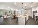 Open living space boasts a modern kitchen, dining area, and stylish living room with natural light at 947 Edwin Ln, Sugar Hill, GA 30518