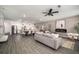 Open-concept living room and kitchen featuring wood floors, modern lighting, and stainless steel appliances at 947 Edwin Ln, Sugar Hill, GA 30518
