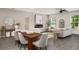 Open-concept living area with an electric fireplace, modern furnishings, and a well-lit dining space at 947 Edwin Ln, Sugar Hill, GA 30518