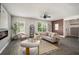Bright living room featuring an electric fireplace, plush seating, and natural light throughout the space at 947 Edwin Ln, Sugar Hill, GA 30518