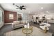 Open concept living room featuring a brick accent wall, modern furnishings, and an inviting atmosphere at 947 Edwin Ln, Sugar Hill, GA 30518