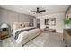 Comfortable main bedroom with neutral tones, carpet floors, a ceiling fan, and ample natural light at 947 Edwin Ln, Sugar Hill, GA 30518