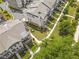 An aerial view of brick townhomes with grassy backyards and sidewalk lined streets at 134 Everley Walk, Alpharetta, GA 30009