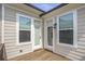 Outdoor balcony featuring natural siding and light filled windows and doors at 134 Everley Walk, Alpharetta, GA 30009